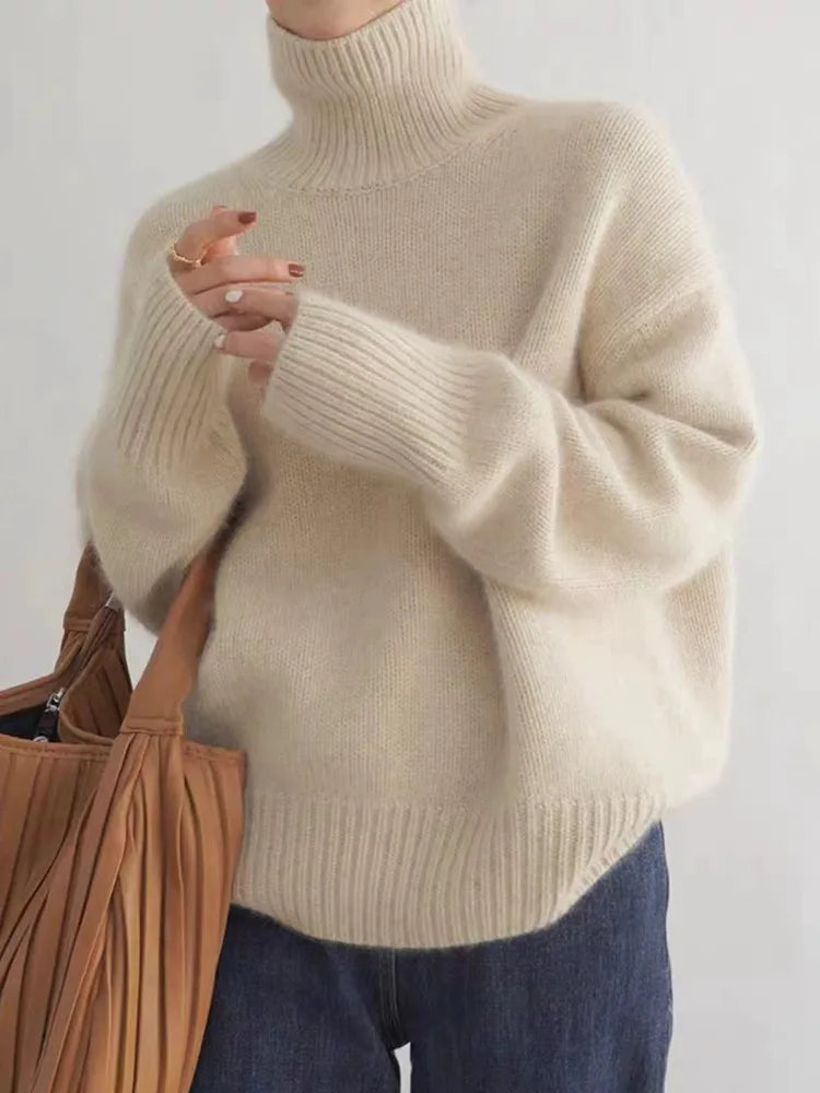 Adalyn ribbed turtleneck sweater in beige, front view with tote bag