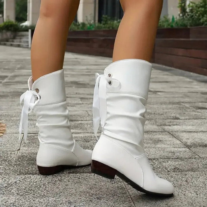 Red slouchy lace-up block heel mid-calf boots walking, side profile