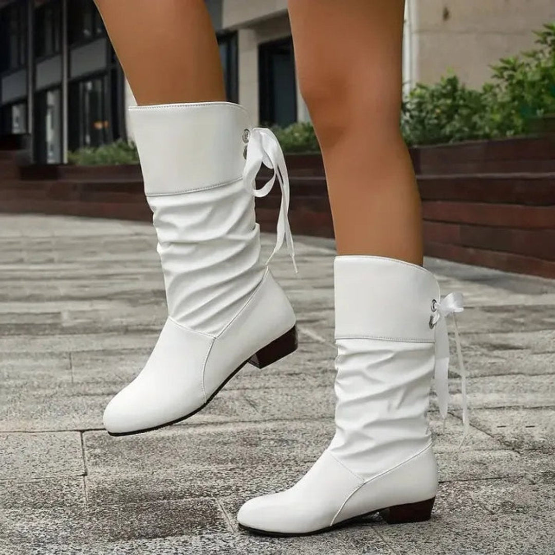 White slouchy lace-up block heel mid-calf boots walking, side view