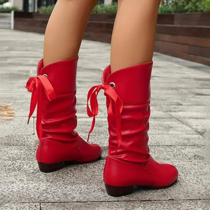 Red slouchy lace-up block heel mid-calf boots walking, side view