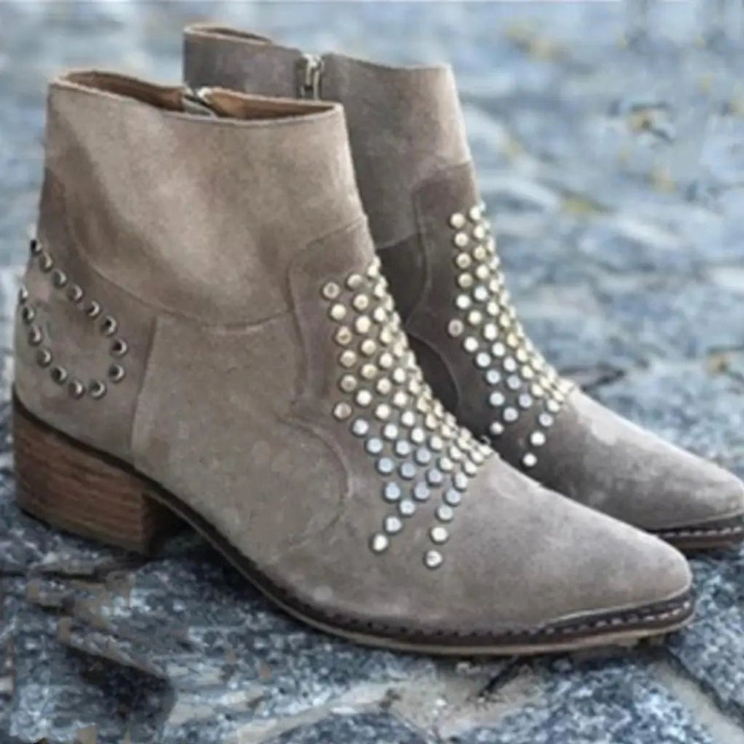 Adeline studded block heel booties, pair displayed on stone surface