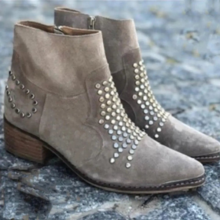 Adeline studded block heel booties, pair displayed on stone surface