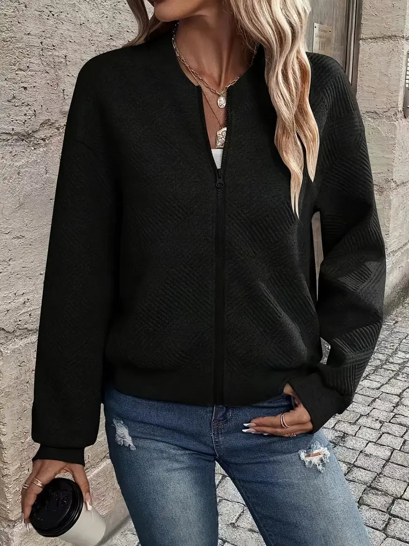 Adeline textured zip-up bomber jacket in black, front view with coffee cup