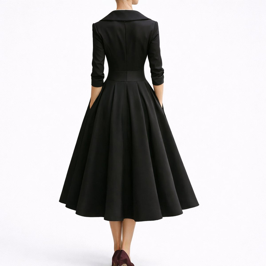 Adeline black wrap V-neck midi dress, back view showing zipper and flared skirt
