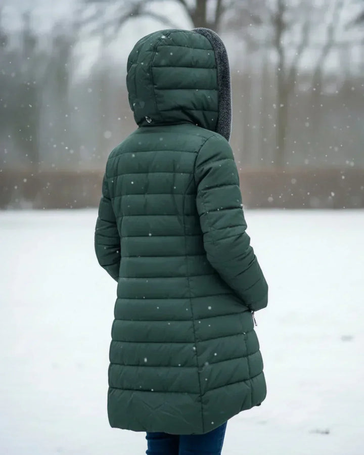 Beatrix hooded long puffer jacket in black, front view outdoors