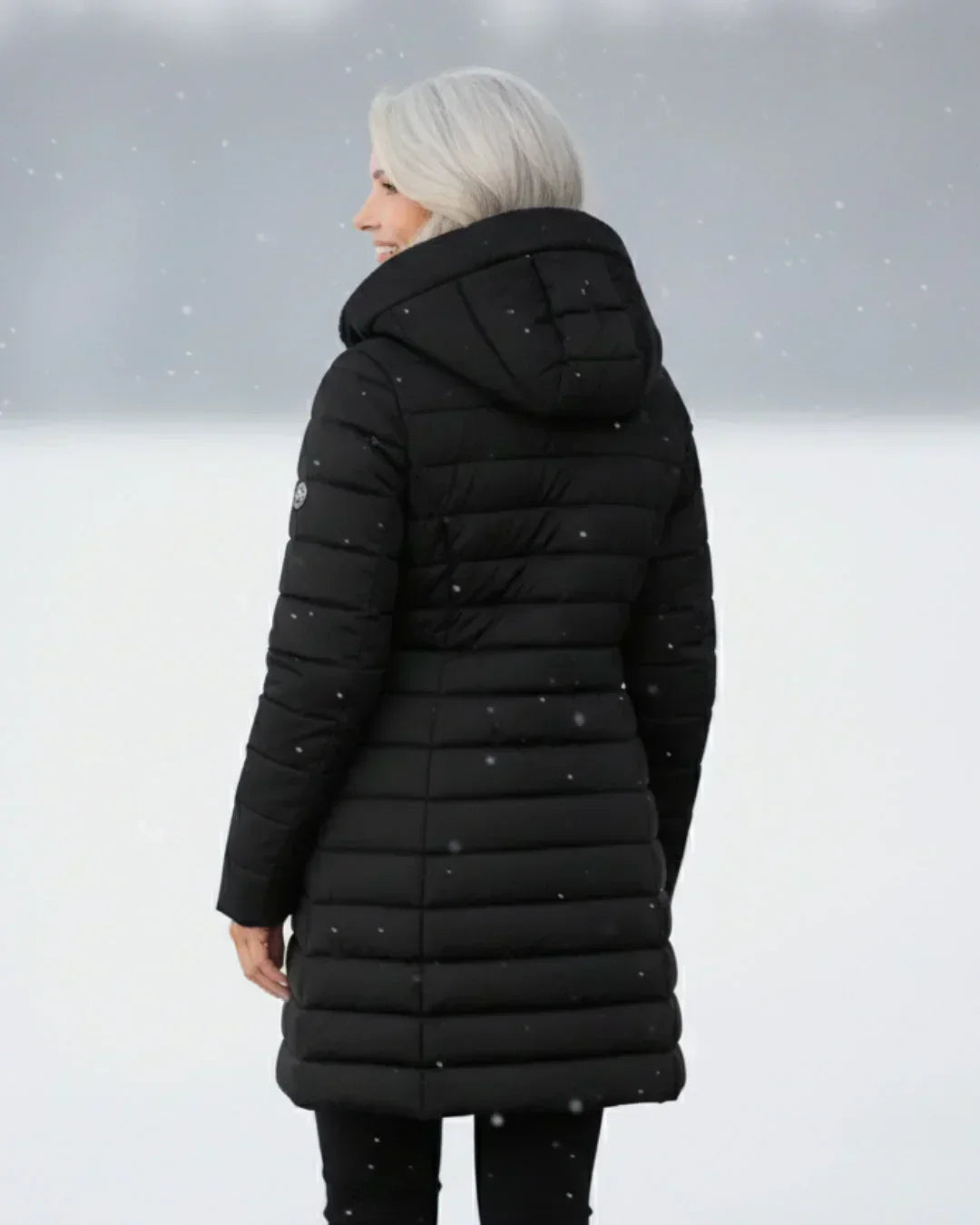Beatrix hooded long puffer jacket in black, front view outdoors