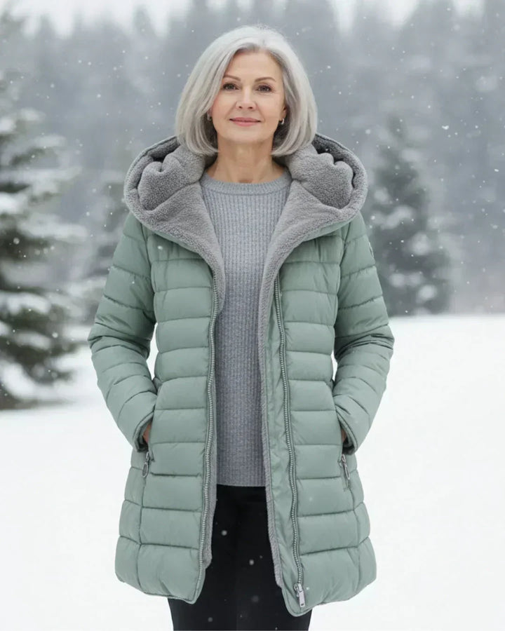 Beatrix hooded long puffer jacket in sage green, outdoor snow scene