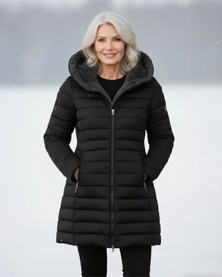 Beatrix hooded long puffer jacket in black, front view outdoors