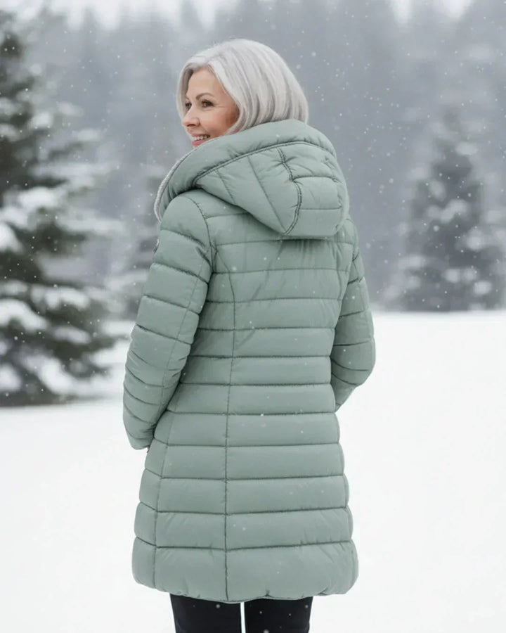 Beatrix hooded long puffer jacket in black, front view outdoors