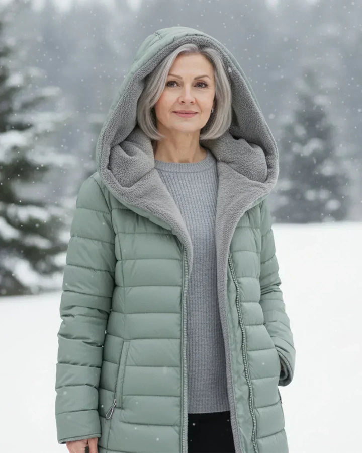 Beatrix hooded long puffer jacket in black, front view outdoors