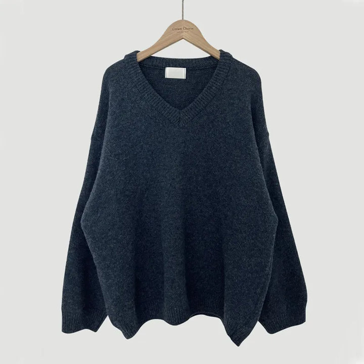 Cassandra V-neck ribbed trim sweater in dark gray, front view on hanger