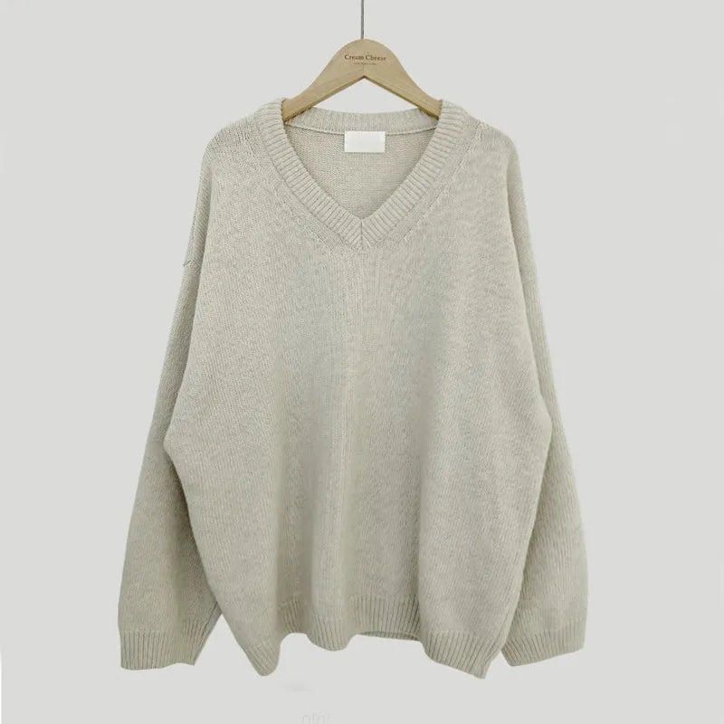 Cassandra V-neck ribbed trim sweater in apricot, front view on hanger