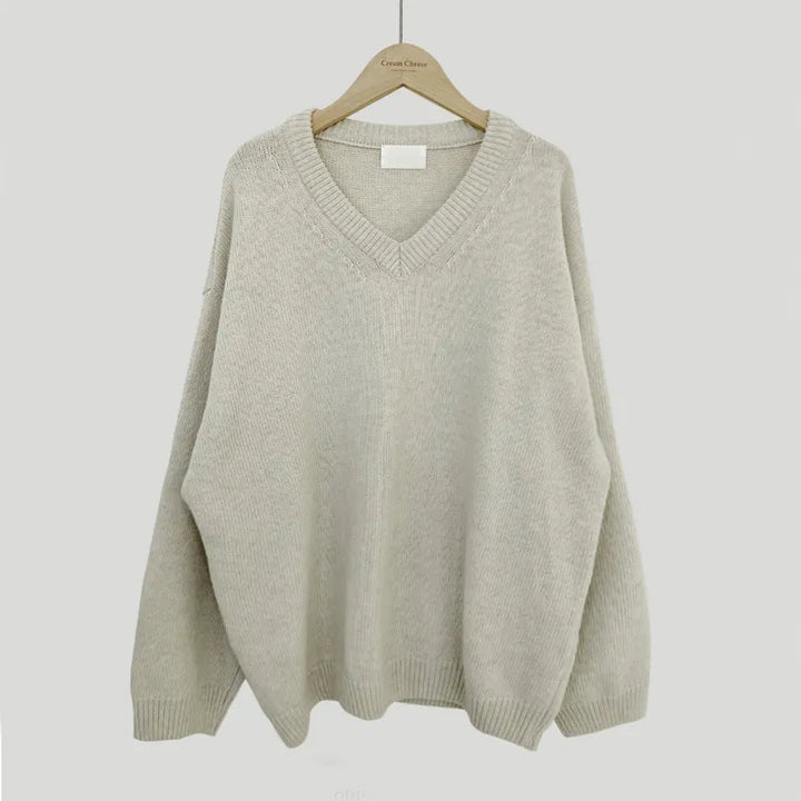 Cassandra V-neck ribbed trim sweater in apricot, front view on hanger