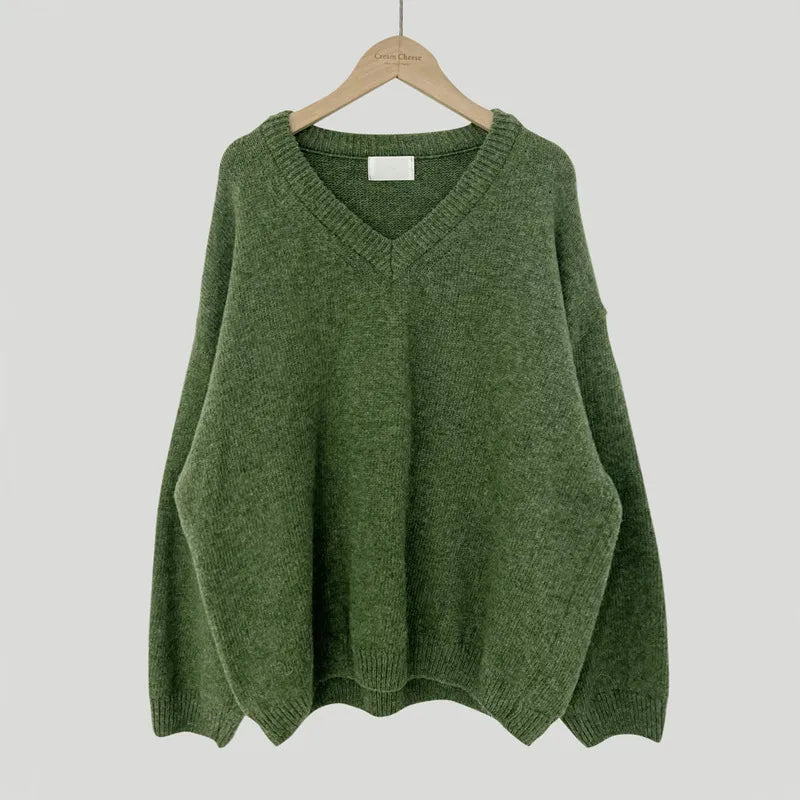 Cassandra V-neck ribbed trim sweater in green, front view on hanger