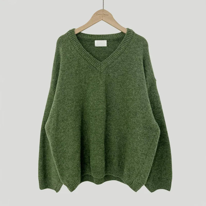 Cassandra V-neck ribbed trim sweater in green, front view on hanger