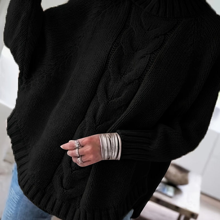 Colette oversized cable-knit sweater in black, back detail close up