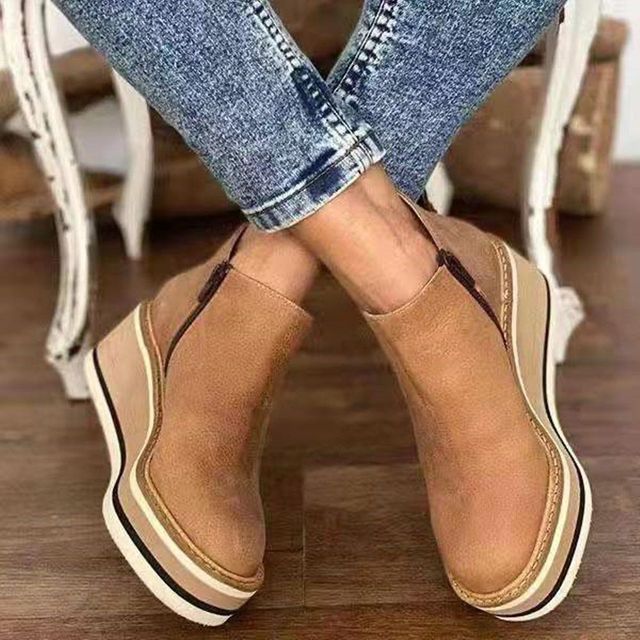 Coraline wedge platform boots, crossed-ankle side view