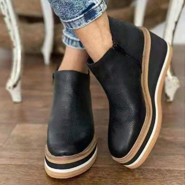 Coraline platform boots in black leather, side view