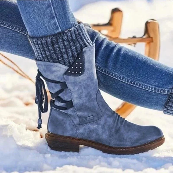 Corinne lace-up mid-calf boots in blue with knit cuff, side view on model
