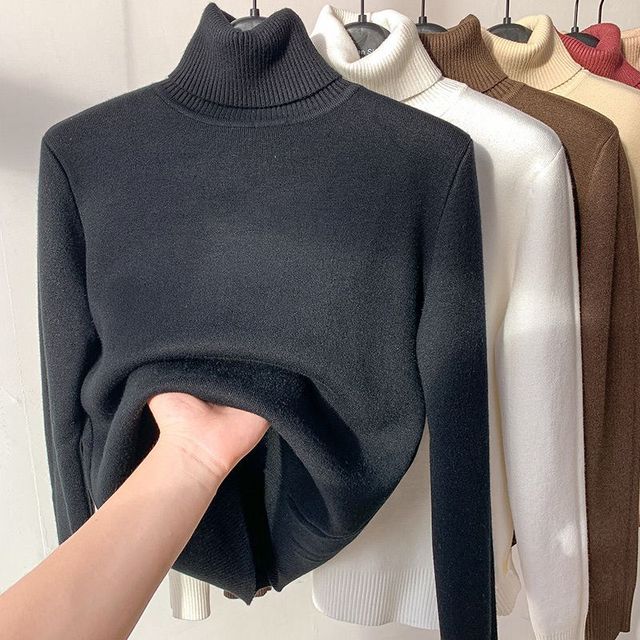 Everly turtleneck sweater in black with fleece lining pulled open