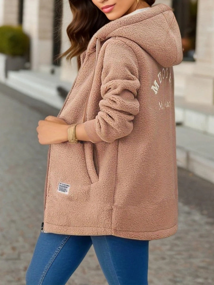Fenella hooded teddy coat in tan, side view showing hood and back embroidery
