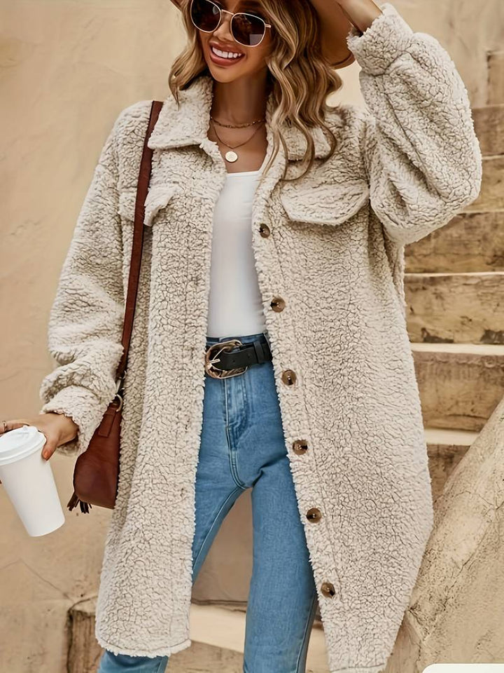 Fenwick teddy coat styled with jeans and sneakers, smiling model