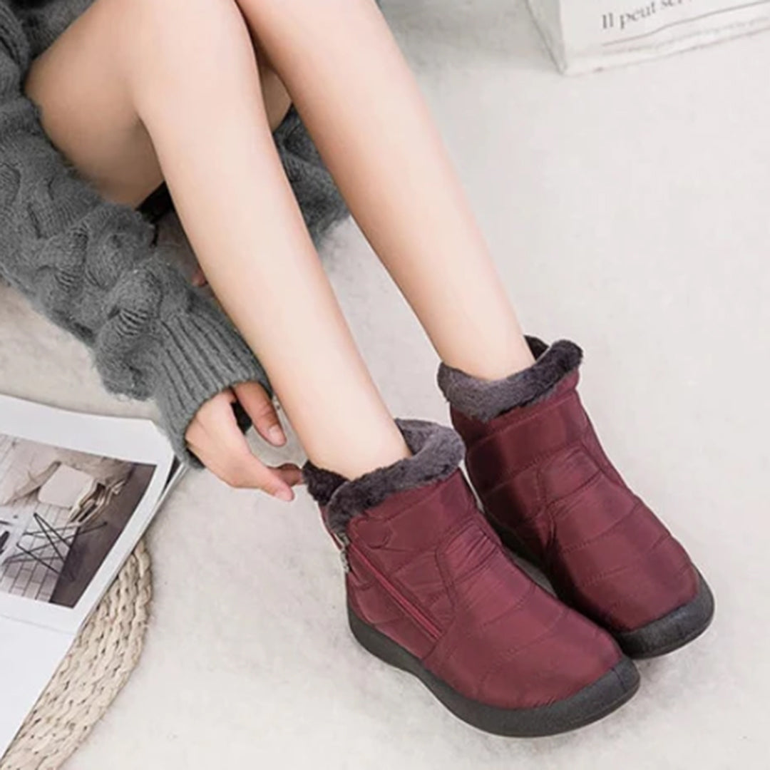 Genevieve burgundy snow boots worn on model, seated view