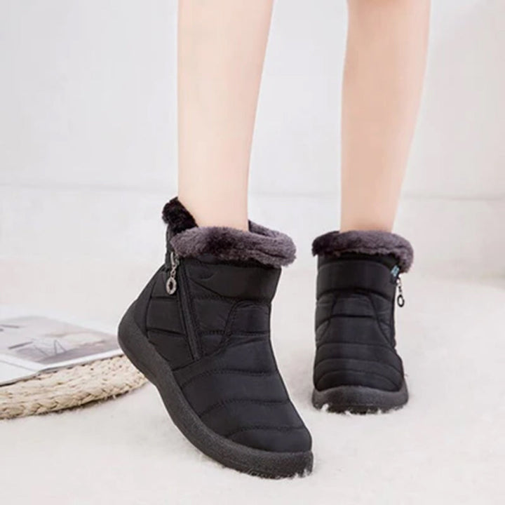 Genevieve black fur trim snow boots worn on model, back view