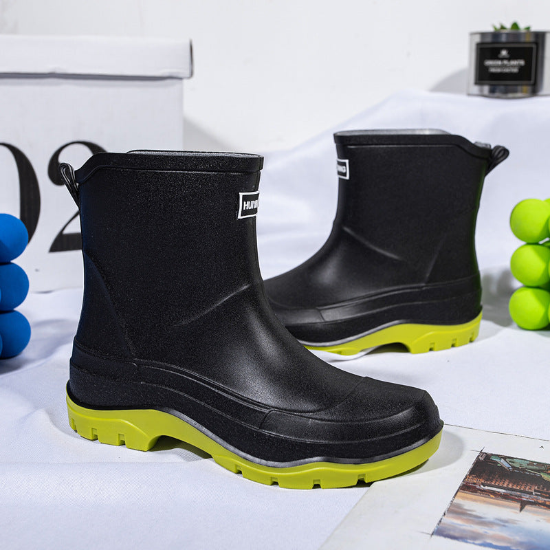 Genevieve black rain boots with neon green contrast sole, front view