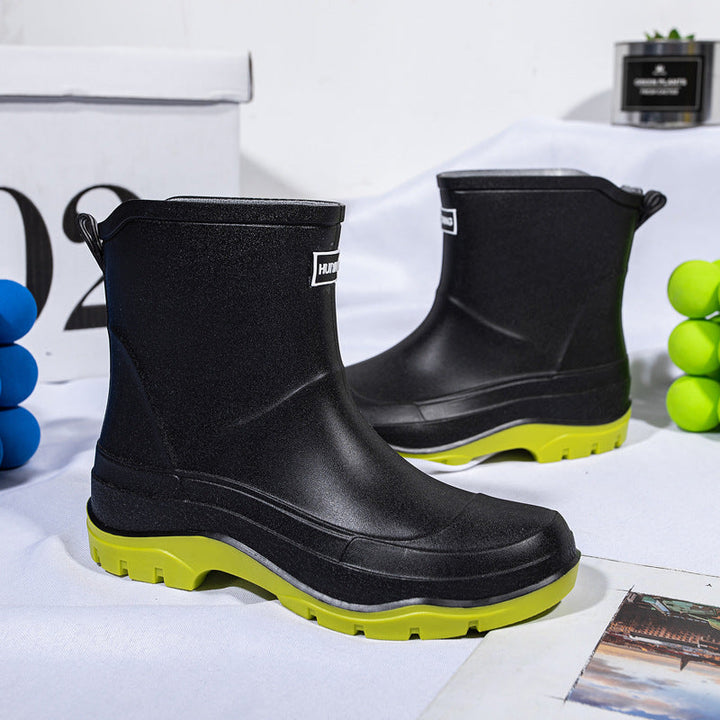 Genevieve black rain boots with neon green contrast sole, front view