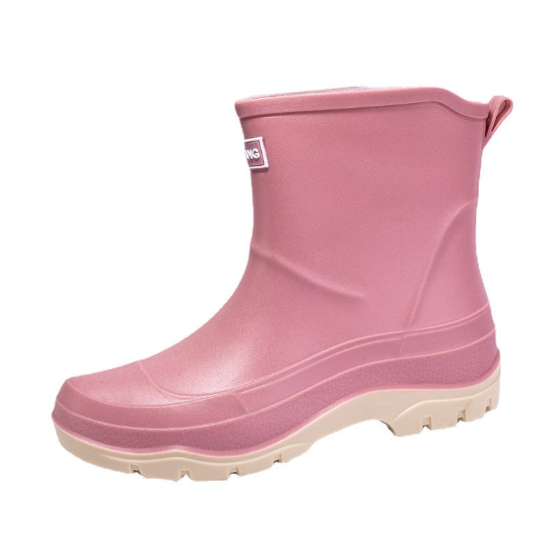 Genevieve black rain boots with neon green contrast sole, front view