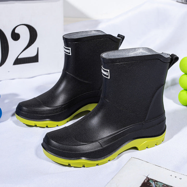 Genevieve black rain boots with neon green contrast sole, front view
