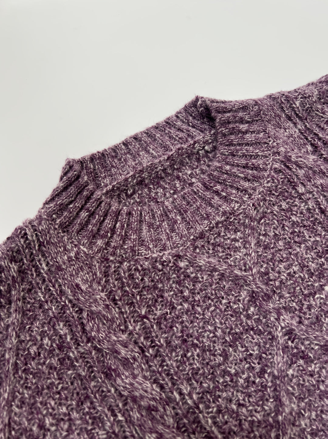 Georgette cable-knit sweater dress fabric close-up at shoulder seam