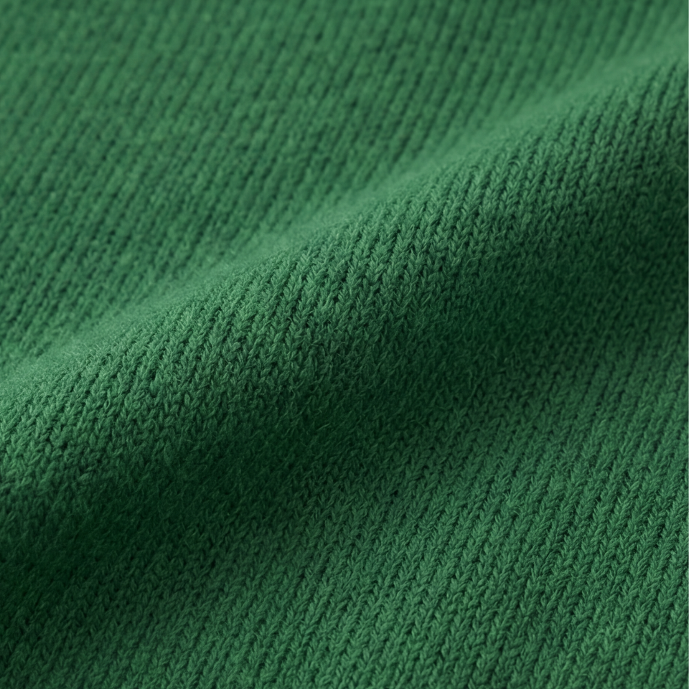 Guinevere asymmetric collar knit sweater, worn at a cafe table