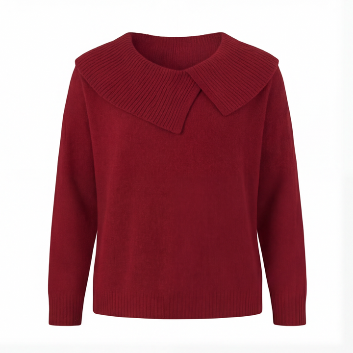 Guinevere asymmetric collar knit sweater, worn at a cafe table