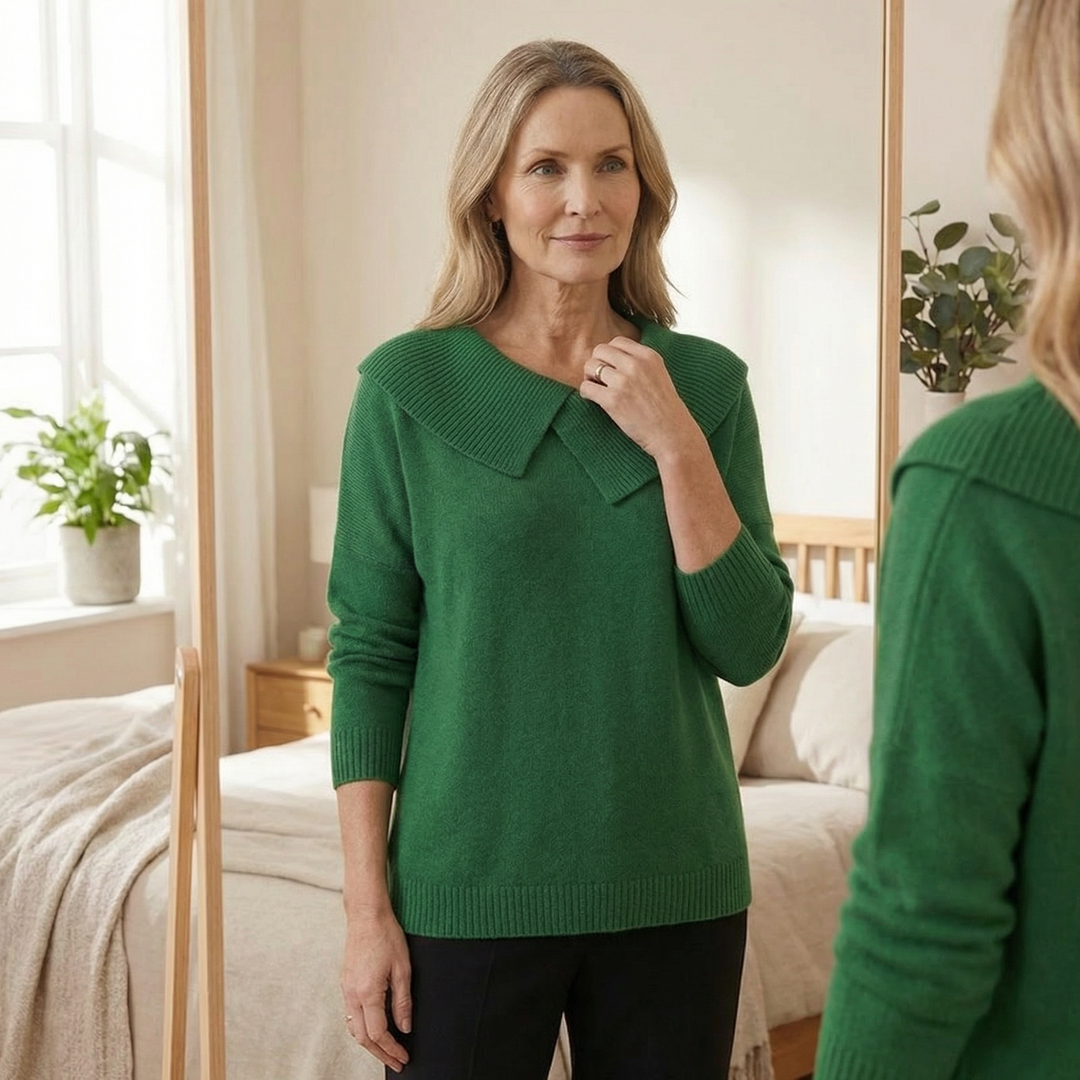 Guinevere asymmetric collar knit sweater, worn indoors adjusting collar