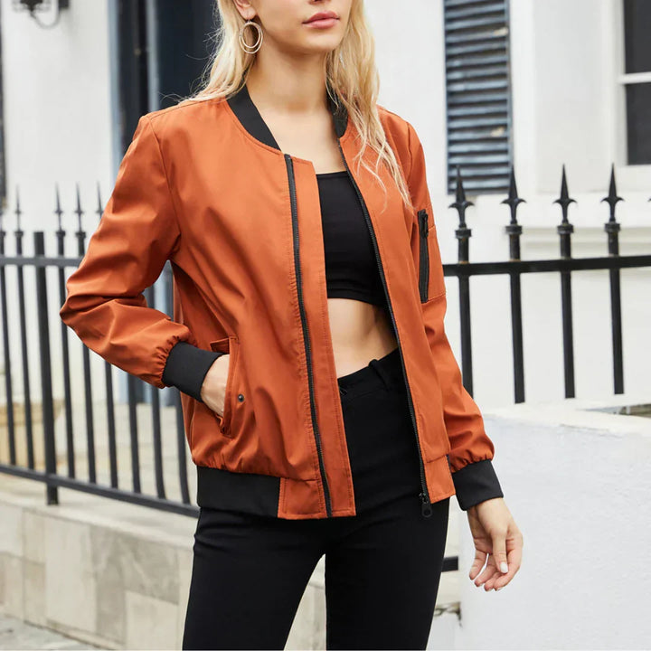 Harlow casual bomber jacket in rust orange, front view styled with black top