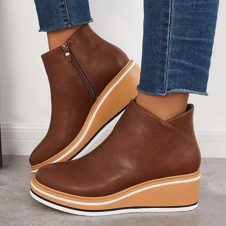 Harlow brown wedge ankle boots worn with jeans, side view