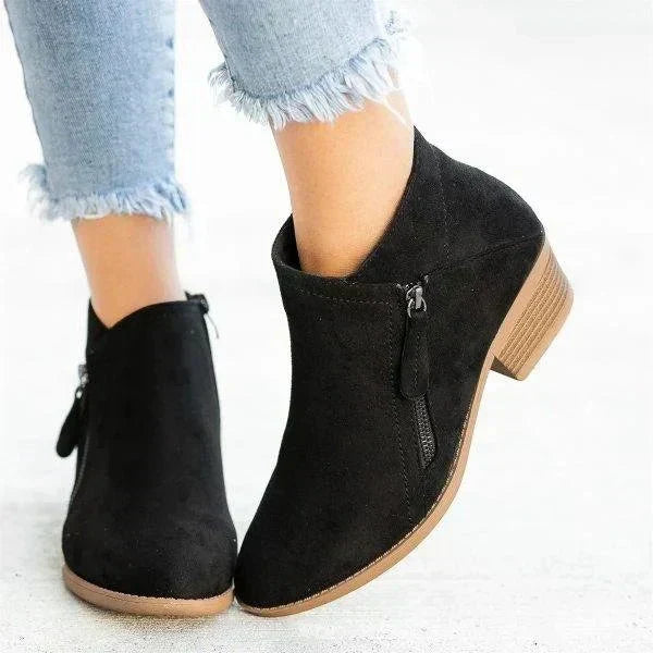Harlow black ankle boots with side-zip design, side profile view