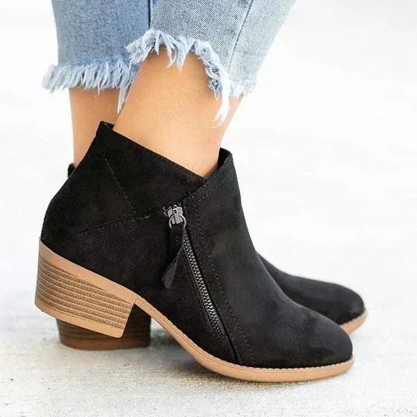 Harlow black ankle boots with side-zip design, close-up side view