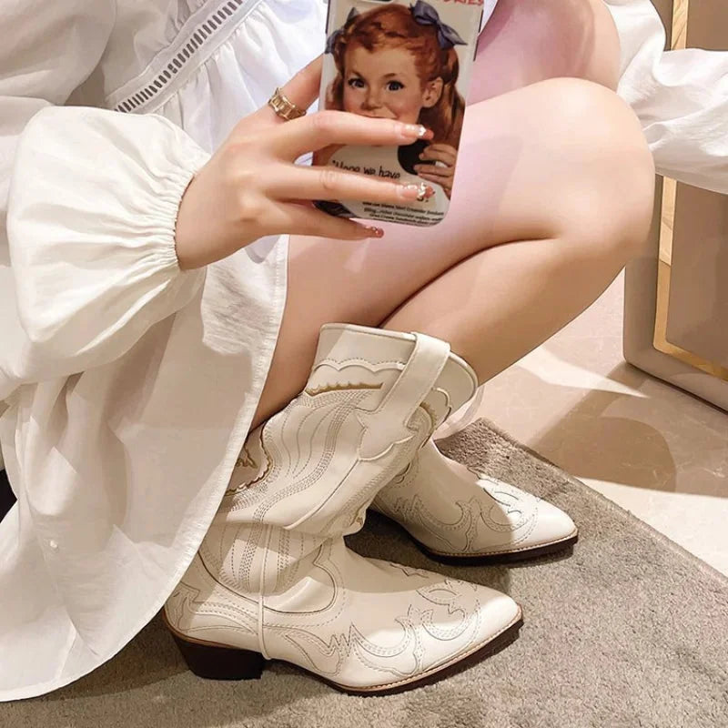 Juniper embroidered cowboy boots with phone in hand, lifestyle close-up