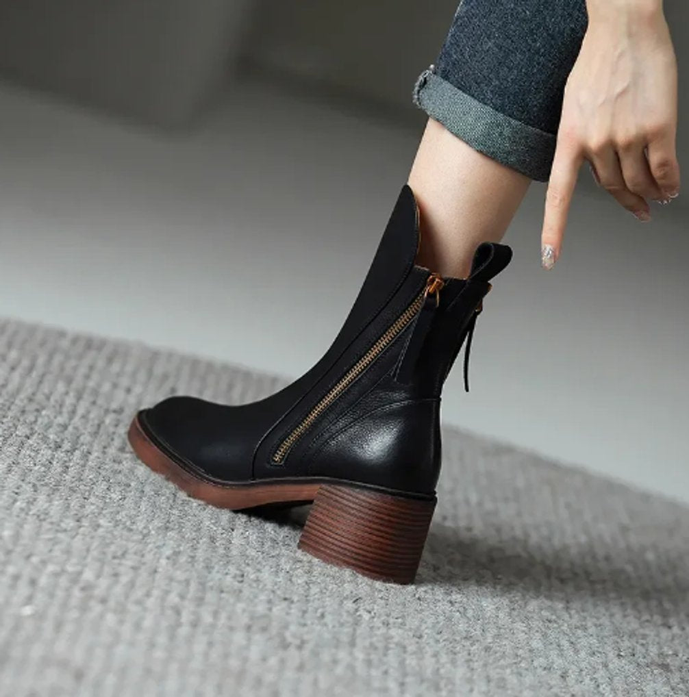 Juniper black ankle boot close-up on foot showing zipper and heel