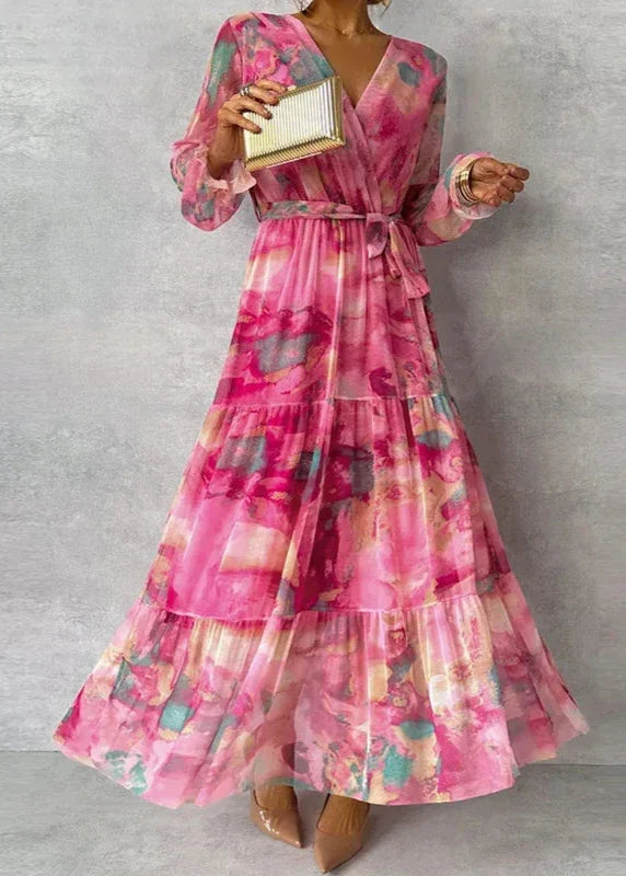 Katie floral wrap maxi dress with V-neck, close-up front view holding gold clutch
