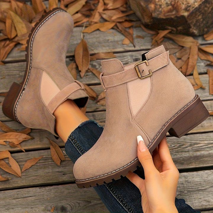 Marguerite Chelsea ankle boots held up close in taupe