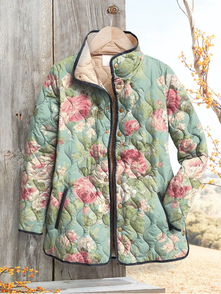 Marguerite floral print quilted jacket hanging on wooden door, front view