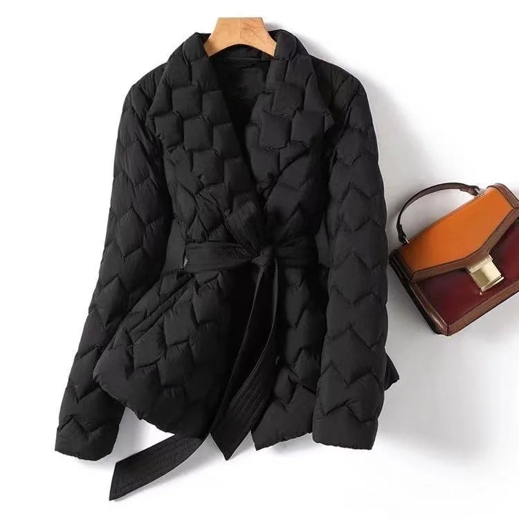 Marguerite quilted belted puffer jacket in black, front view with handbag accessory