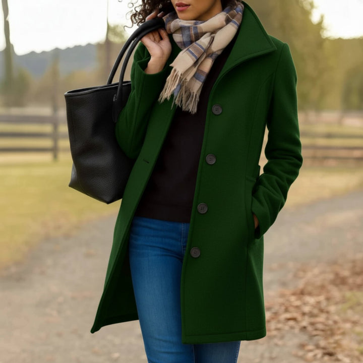 Marielle classic single-breasted mid-length coat in dark green, front view with scarf and tote bag