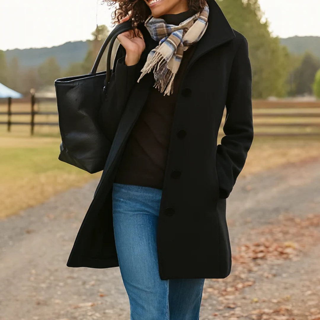 Marielle classic single-breasted mid-length coat in black, front view walking outdoors