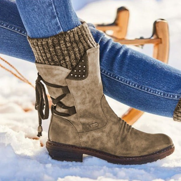 Marielle taupe knit cuff lace-up mid-calf boots on snowy ground, side view