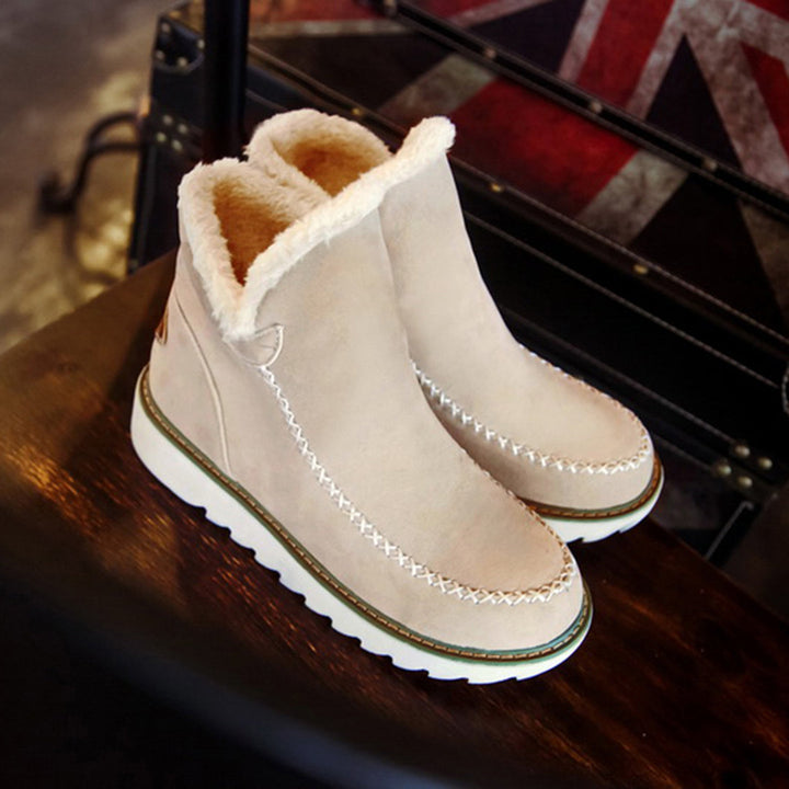 Marigold platform boots in beige, angled view on trunk